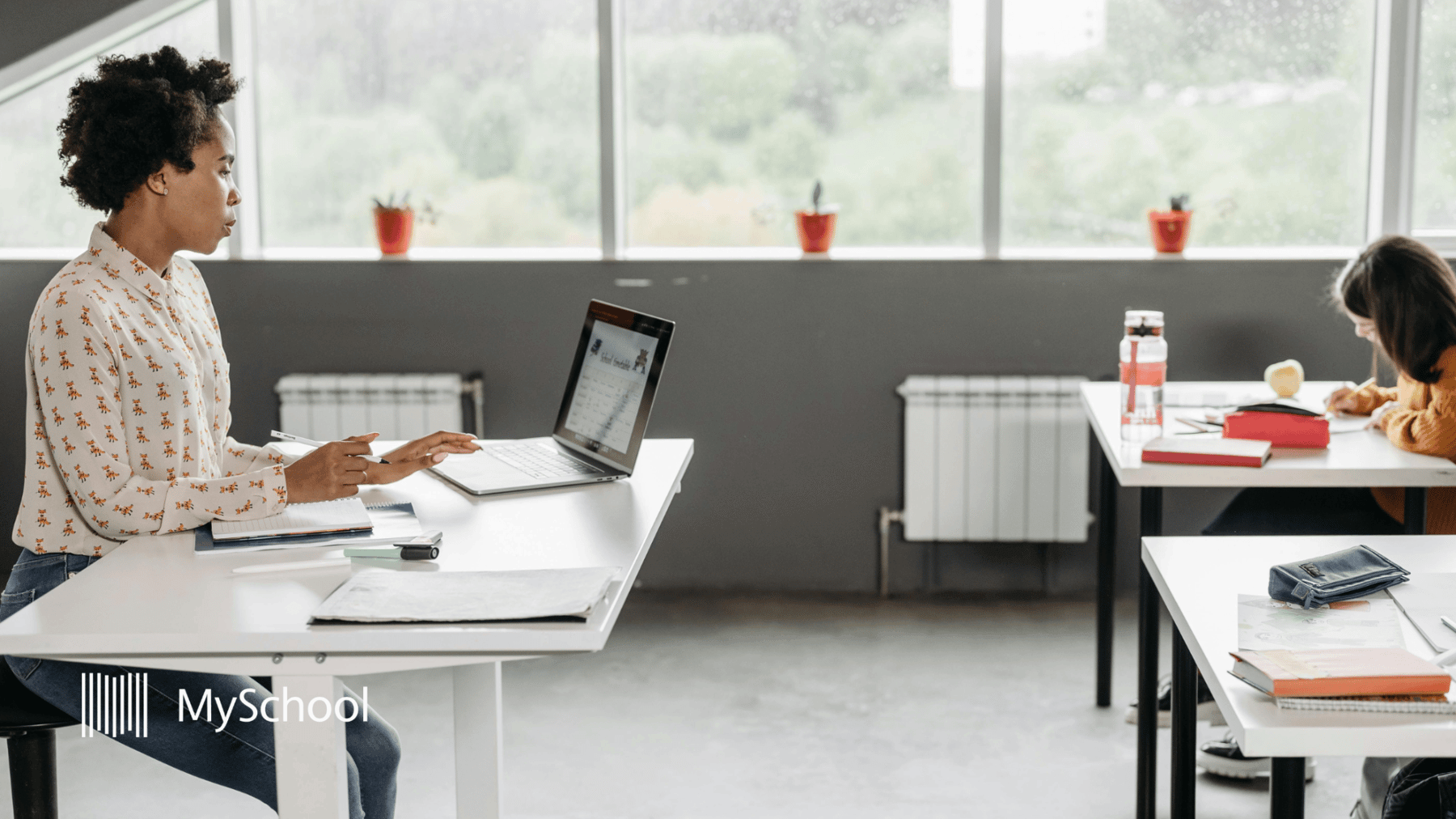 Teacher using K-12 school management software in the classroom for lessons and student information