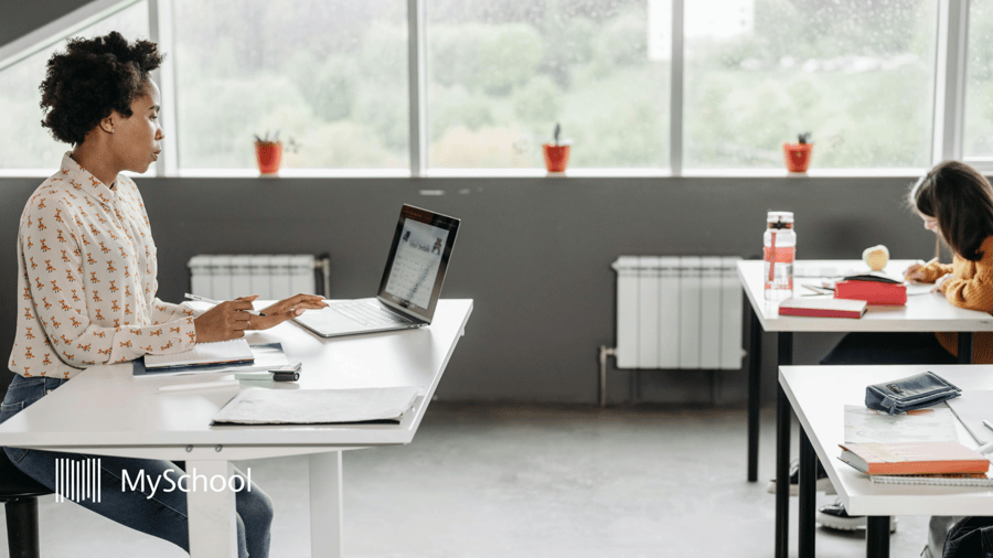 Teacher using K-12 school management software in the classroom for lessons and student information