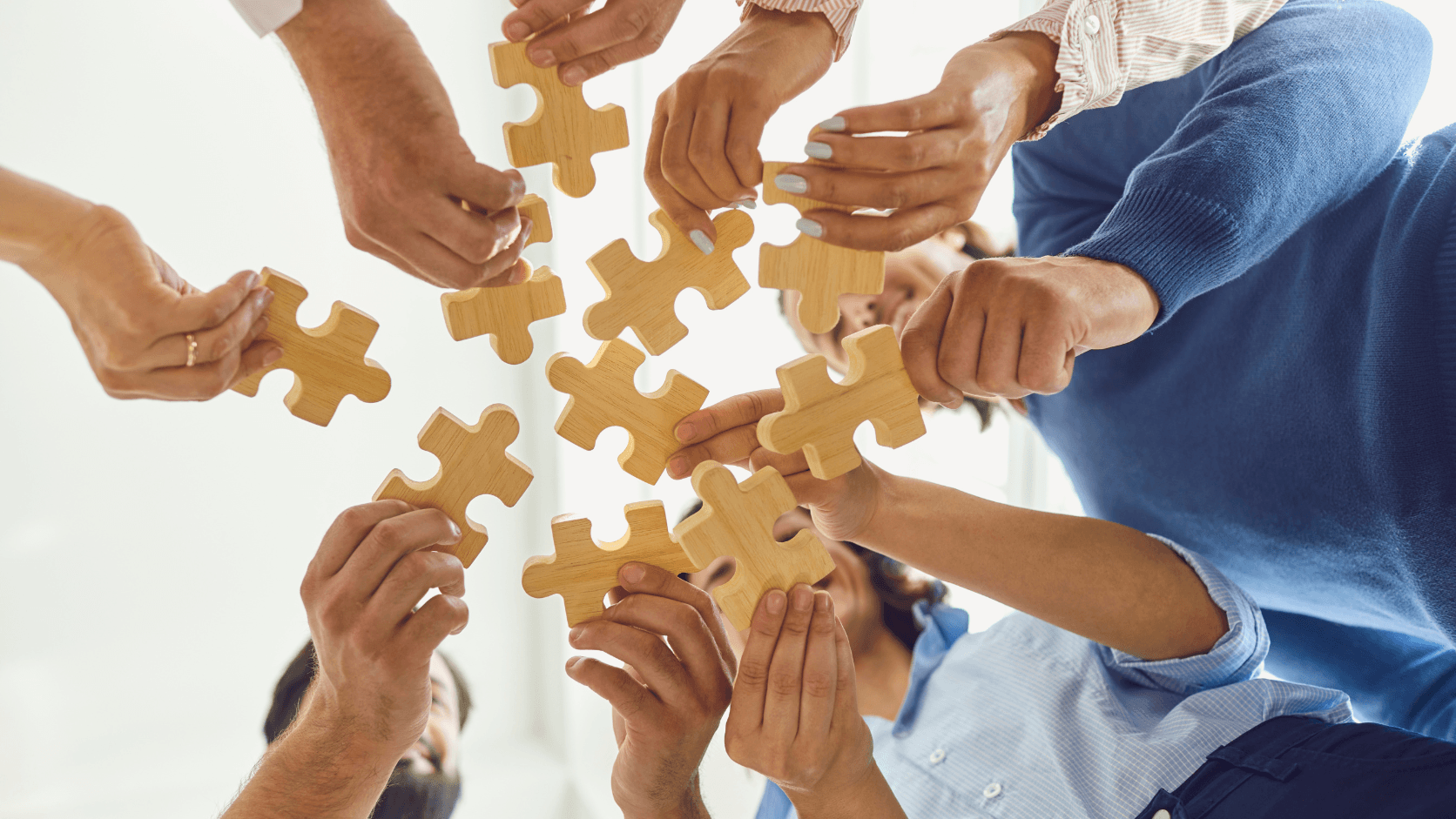 People connecting puzzle pieces together to represent MySchool team