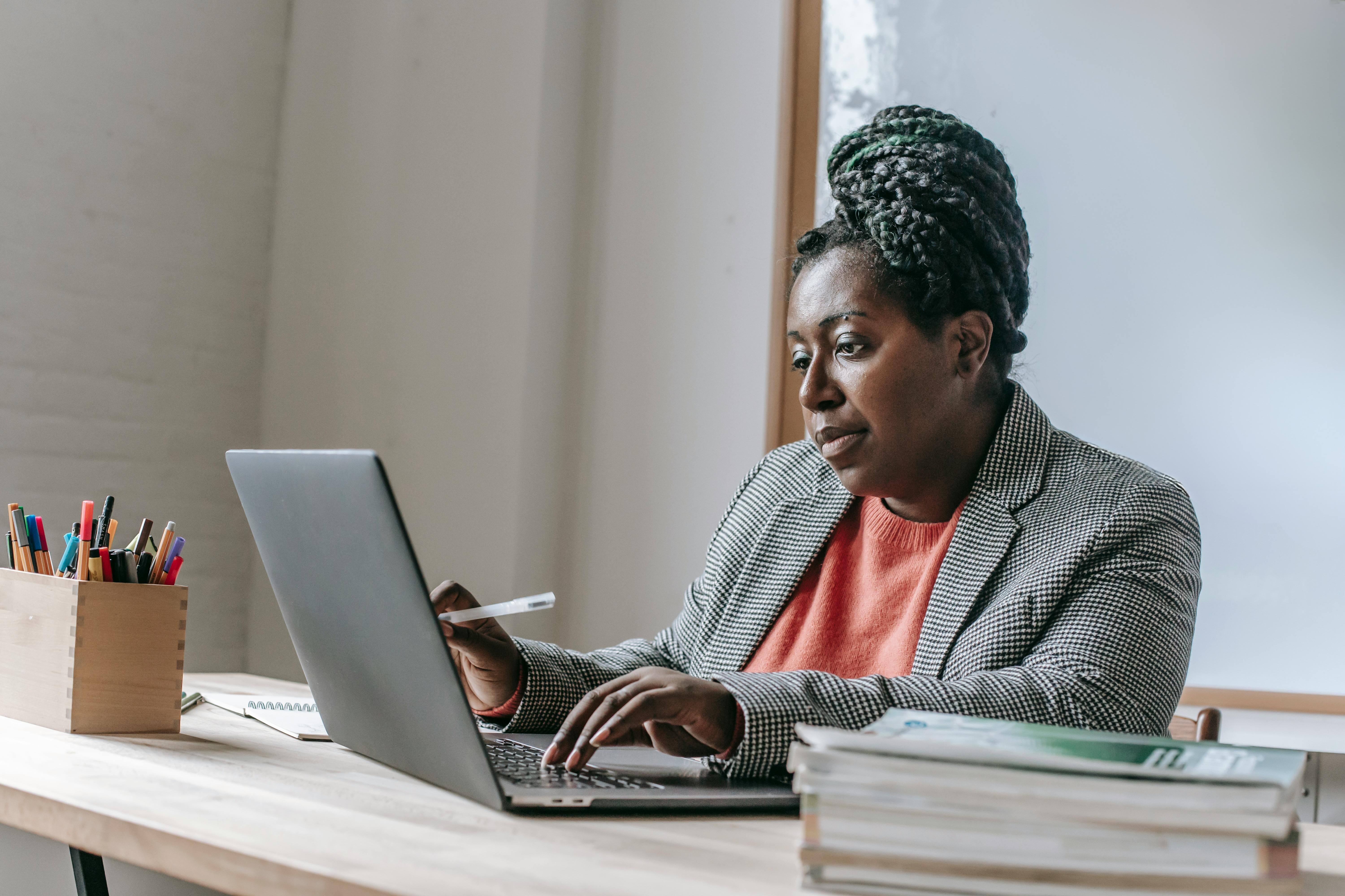 School staff member completing role-specific onboarding and training on a laptop during school software implementation