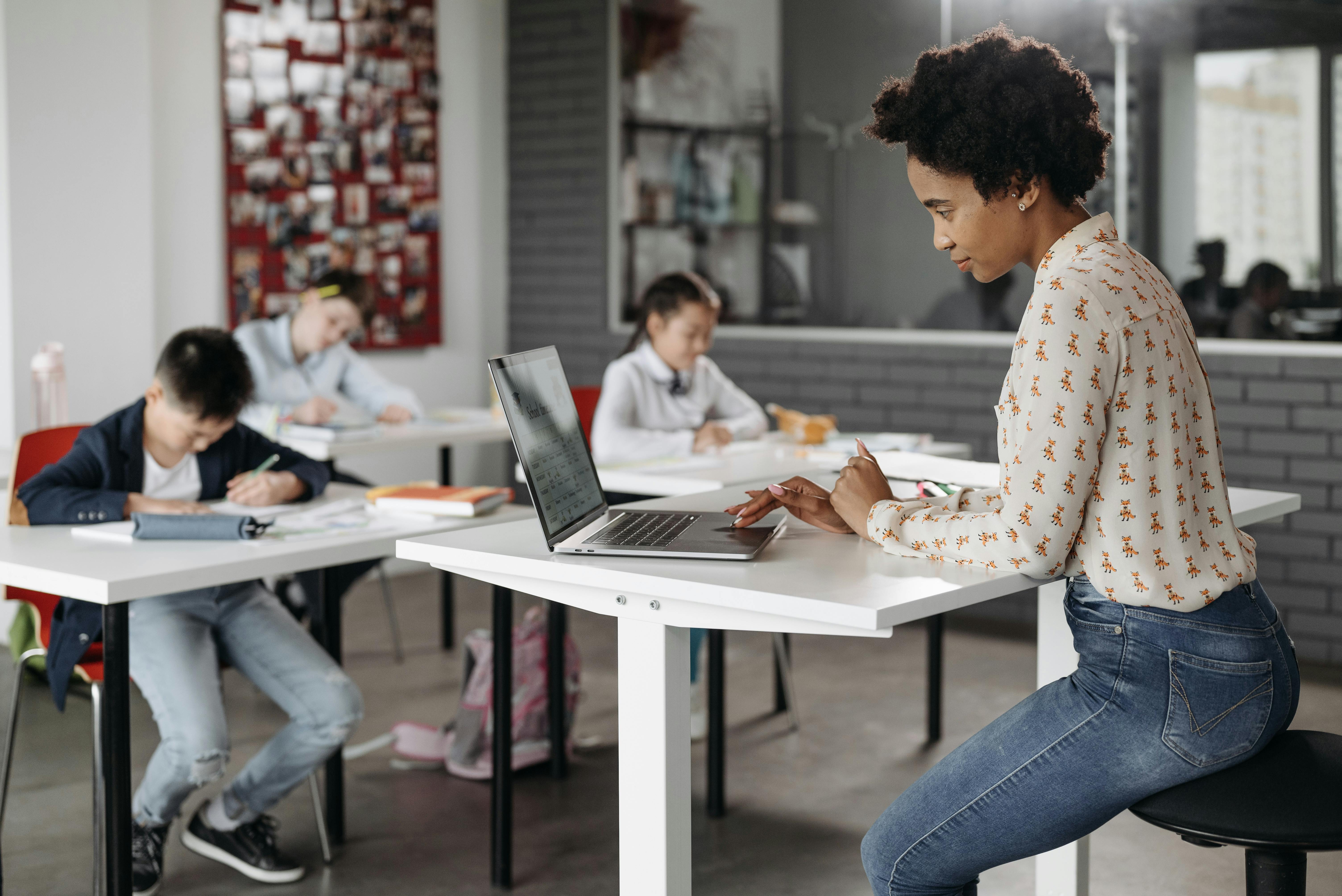 Teacher using a unified school management platform in the classroom to connect academics, attendance, communication, and student data