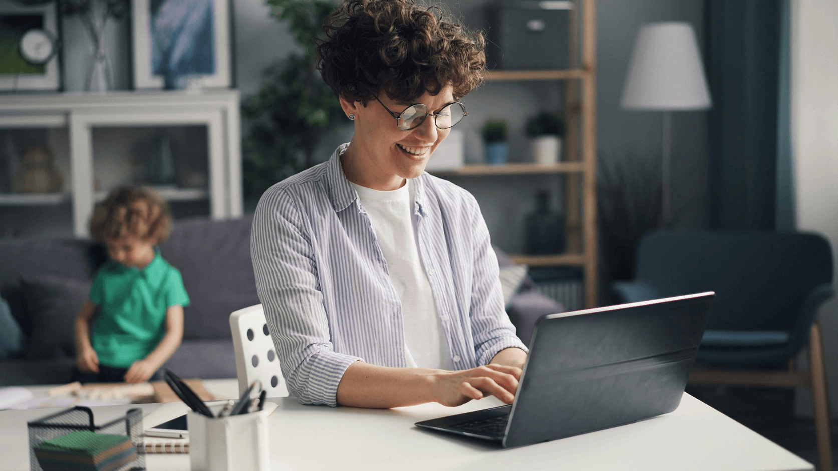 Mother using MySchool platform on her laptop, checking school communication at home